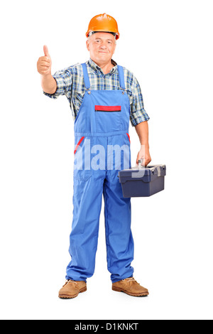 Full length portrait of a manual worker holding tool box and giving a thumb up isolated on white background Stock Photo