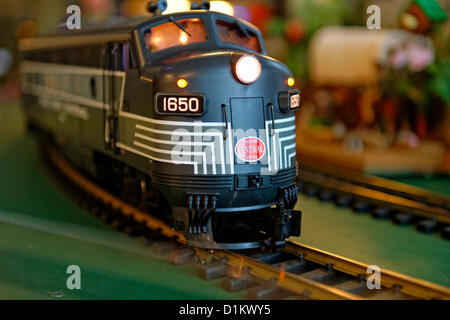 Dec. 26, 2012 - Garden City, New York, U.S. - The Long Island Garden Railway Society large-scale model train display is a festive winter holiday attraction in the vast 3-floor atrium of Cradle of Aviation museum. This is close-up of a G-scale New York Central engine. LIGRS shares the knowledge, fun, and camaraderie of large-scale railroading both indoors and in the garden, and is family oriented. Stock Photo