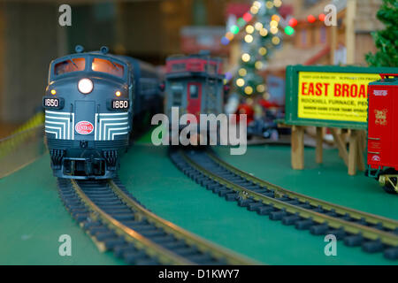 Dec. 26, 2012 - Garden City, New York, U.S. - The Long Island Garden Railway Society large-scale model train display is a festive winter holiday attraction in the vast 3-floor atrium of Cradle of Aviation museum. The G-scale New York Central and other train pass each other in opposite directions. LIGRS shares the knowledge, fun, and camaraderie of large-scale railroading both indoors and in the garden, and is family oriented. Stock Photo