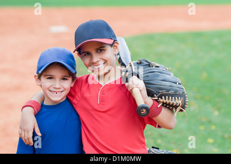 Hispanic boys in baseball uniforms Stock Photo