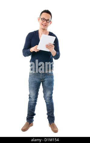 south east asian man with a tablet in casual standing Stock Photo