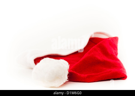 Red and white Santas Hat lying down isolated against a white background Stock Photo