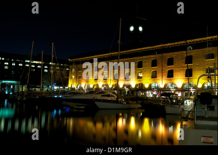 Luxury yachts harboured or moored at Saint Katherine Docks by night, Tower Hamlets, London, England, UK Stock Photo