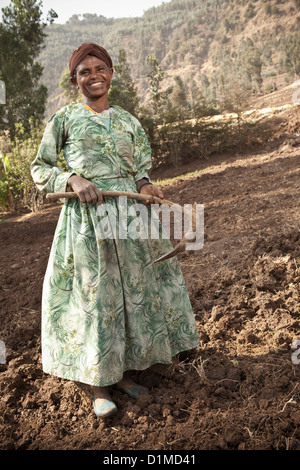 A farmer tills her farmland in Ankober, Ethiopia. Stock Photo