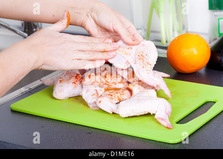 Chicken wings cooking process in kitchen Stock Photo