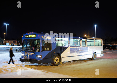 Saskatoon transit bus on frozen snow covered street in Saskatchewan Canada Stock Photo
