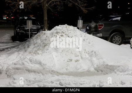 pile of snow stacked in parking lot Saskatoon Saskatchewan Canada Stock Photo