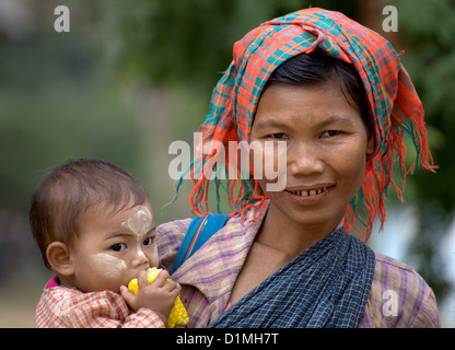 A Burmese woman with her Children in Bagan,Myanmar,Burma.A beautiful Burmese girl with  tanaka with her mother in Bagan,Burma Stock Photo