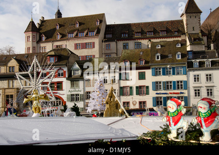 Switzerland, Basel. Basel Winter Holiday Market (aka Basler Weihnacht) at Barfusserplatz. Holiday roof top decorations. Stock Photo