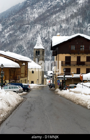 A narrow street in an alpine village, after a heavy snowstorm, Italy Stock Photo