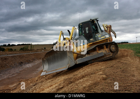 Bull Dozer construction machines on new motorway Stock Photo