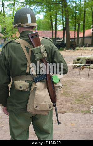 soldier seen from behind wearing a weapon on his back Stock Photo