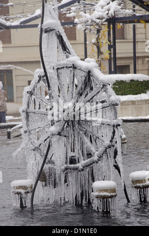 Switzerland, Basel. Tinguely Fountain, by artist Jean Tinguely. Mechanical working fountain sculpture covered in winter ice. Stock Photo