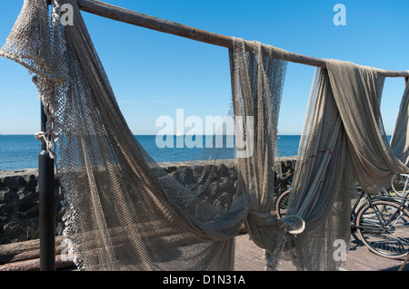 nets of dutch fishing cutter hanging out to dry Stock Photo