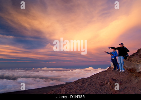 People enjoying the sunset from the summit of Haleakala on the island of Maui. Stock Photo