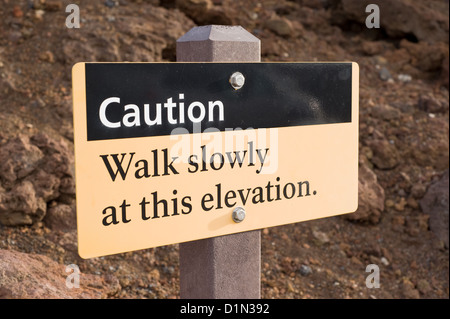 A sign on the summit of Haleakala on the island of Maui warns visitors of the high elevation. Stock Photo