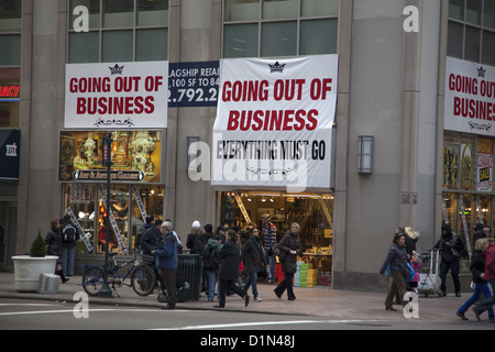 Store on 5th Ave in NYC with large Going Out of Business banners trying to sell off merchandise Stock Photo