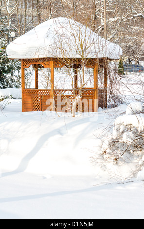 Snow-covered summerhouse in park in winter Stock Photo