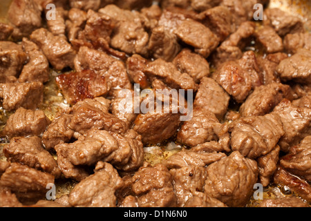 Beef browning in a frying pan Stock Photo