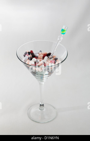 Prescription pills, tablets, capsules and martini glass. White background. Stock Photo