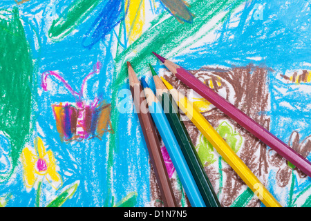 several colored pencils on children picture background Stock Photo