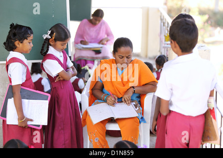 Indian school teacher with children Andhra Pradesh South India Stock Photo