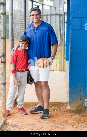 Hispanic coach and young baseball player Stock Photo