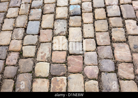 Weathered cobblestone pathway creates a textured and inviting outdoor scene in Prague Stock Photo