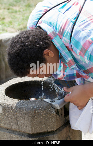 Young man drinking from drinking fountain Stock Photo