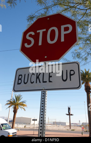 buckle up sign below stop sign in Las Vegas Nevada USA Stock Photo