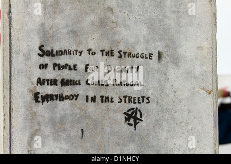 An anarchist graffiti slogan in Lisbon Portugal referring to the Greek economy default and also the possibility of Portugal. Stock Photo