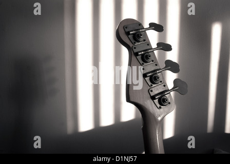 Bass guitar tuning head stock with shadows (music,jazz,blues,funk,rock concept) Stock Photo