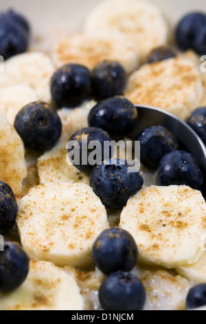 A healthy breakfast. Porridge with banana, blueberries and a sprinkling of cinnamon. Stock Photo