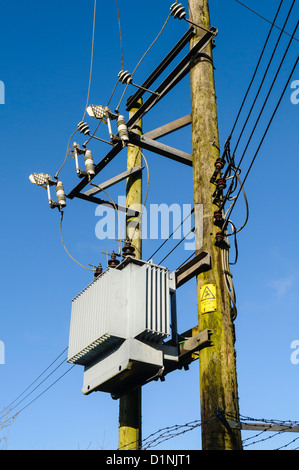 Electricity transformer on two wooden poles. Stock Photo