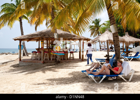 People sunbathing on the beach by the bar, Windjammer Landing, St Lucia, Caribbean West Indies Stock Photo