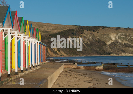 Swanage cliffs and beach huts at the northern end of Swanage bay Stock Photo