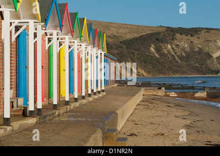 Swanage cliffs and beach huts at the northern end of Swanage bay Stock Photo