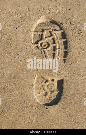 Human footprint in golden beach sand Stock Photo