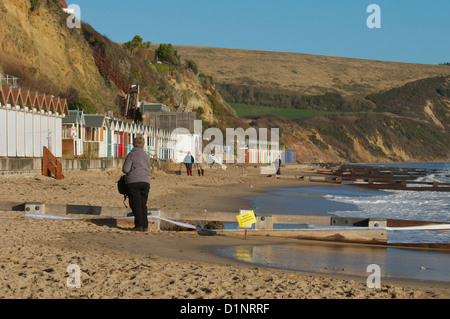 Swanage cliffs and beach huts at the northern end of Swanage bay Stock Photo