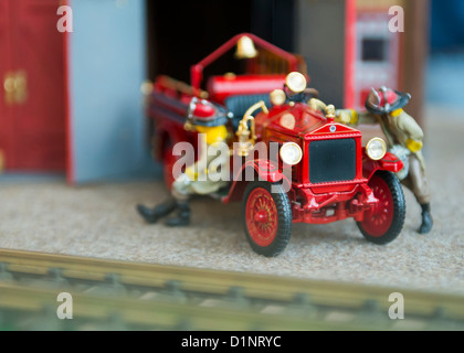 Model of Vintage Fire Truck and 2 Firemen by railway tracks, display at Cradle of Aviation Museum, NY, Dec. 26 2012. Shallow DOF Stock Photo