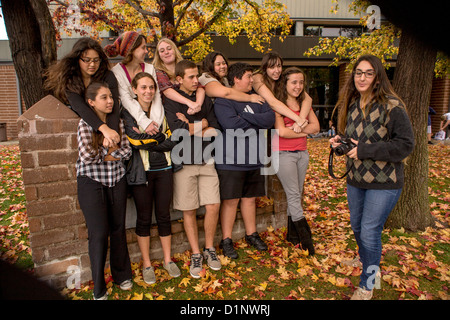 Multiethnic California high school students pose for a classmate's camera on the school's outdoor campus. Stock Photo