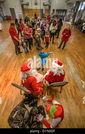 Deaf boy meets a deaf Santa Claus and Mrs. Santa using sign language at Christmas festivities at the California School for Deaf. Stock Photo