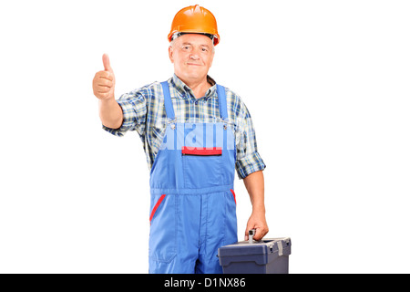 A manual worker holding tool box and giving a thumb up isolated on white background Stock Photo