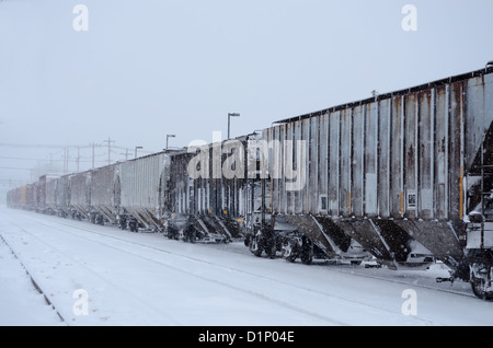 Freight train moves through snow storm in upstate New York, US. Stock Photo