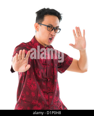 Southeast Asian Chinese man practicing kungfu, isolated on white background Stock Photo