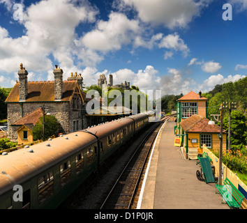 A steam train pulls in to the station at Corfe Castle in Dorset Stock Photo