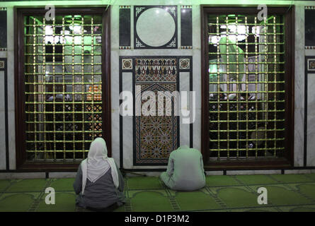 Jan. 1, 2013 - Cairo, Cairo, Egypt - Egyptian Muslims pray at a tomb in al-Hussein mosque, which according to the belief head of Imam Hussein, the grandson of prophet Mohammed, is buried, in the old city of Cairo on Jan. 1, 2013  (Credit Image: © Ashraf Amra/APA Images/ZUMAPRESS.com) Stock Photo