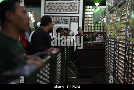 Jan. 1, 2013 - Cairo, Cairo, Egypt - Egyptian Muslims pray at a tomb in al-Hussein mosque, which according to the belief head of Imam Hussein, the grandson of prophet Mohammed, is buried, in the old city of Cairo on Jan. 1, 2013  (Credit Image: © Ashraf Amra/APA Images/ZUMAPRESS.com) Stock Photo