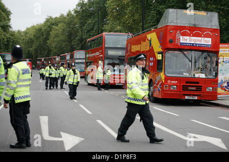 Police and buses parked up outside Hyde Park. Members of DPAC have blocked the road and stopped all traffic in protest. Stock Photo