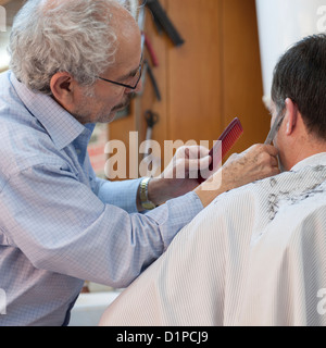 Man receiving a hair cut from barber, Istanbul, Turkey Stock Photo